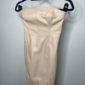 Cream colored tight strapless dress.